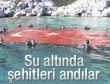 Su altında bayrakla şehitleri andılar